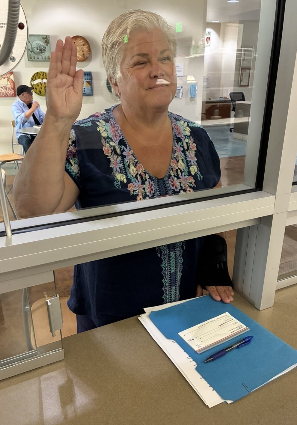 Colleen Martin raising her right hand at the County Clerk-Recorder's office to file her candidacy papers